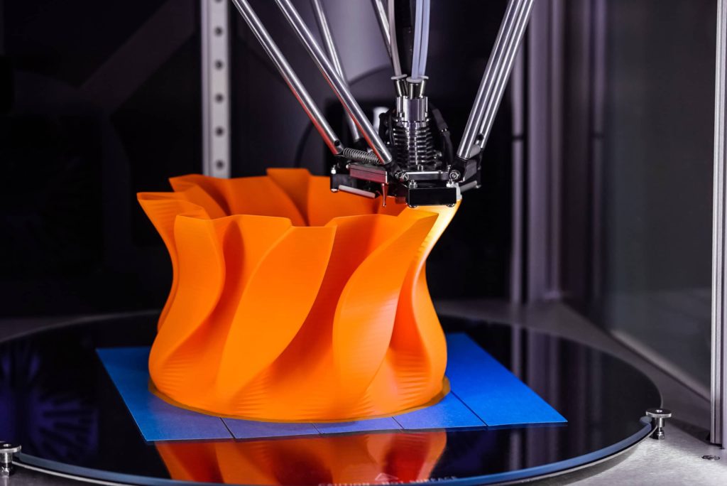 3d printer making an orange object